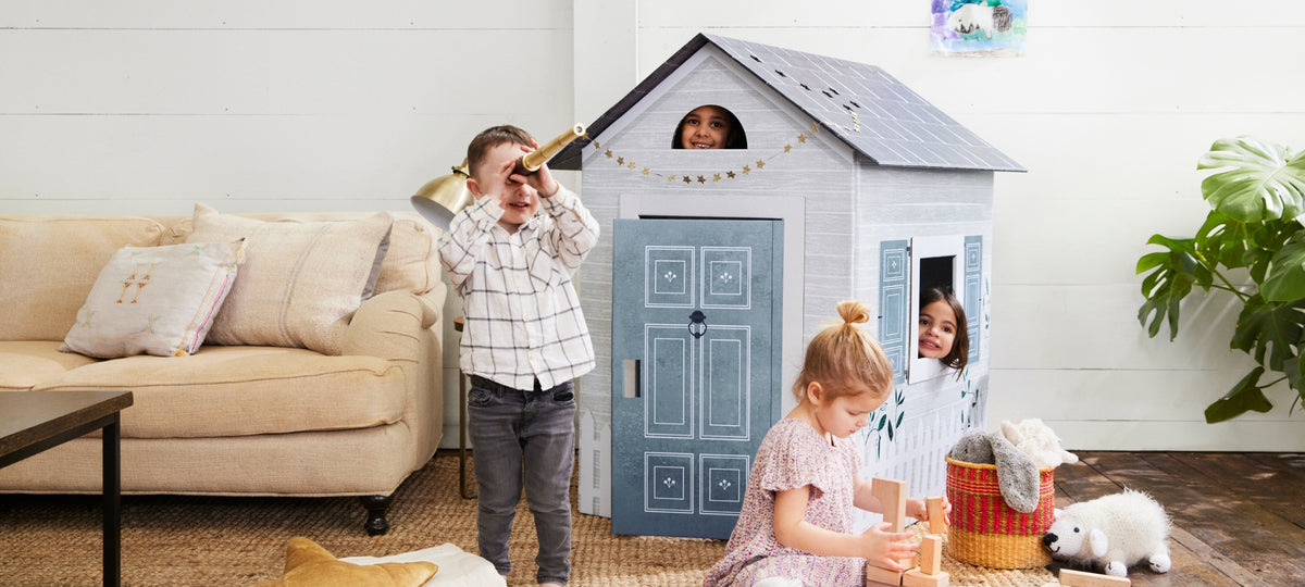 Children playing in a cottage playhouse